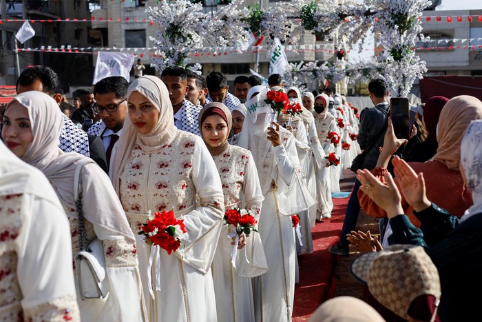 A woman reacts while Palestinians attend a mass wedding for 50 couples organized by the IHH Humanitarian Relief Foundation in Gaza City, May 11, 2026. REUTERS/Mahmoud Issa