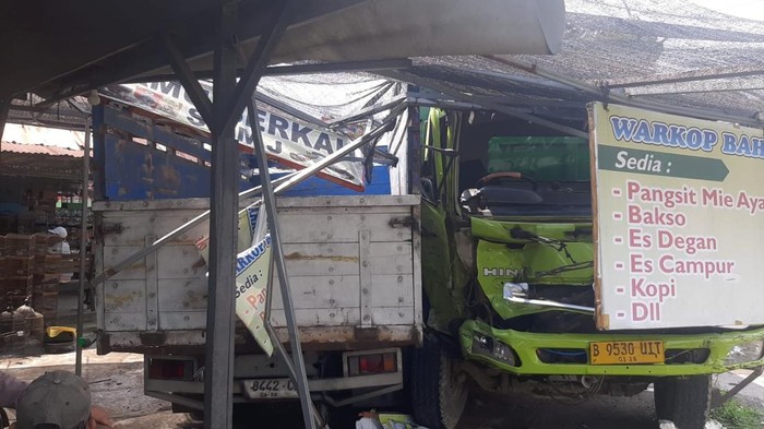Tronton rem blong menabrak sejumlah kendaraan hingga baru berhenti setelah menabrak warung di Menganti, Gresik.