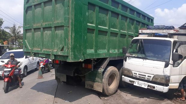 Tronton rem blong menabrak sejumlah kendaraan hingga baru berhenti setelah menabrak warung di Menganti, Gresik.