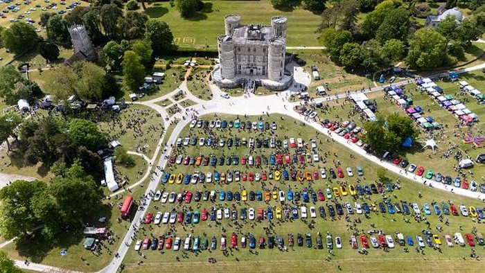 LULWORTH, ENGLAND - MAY 17: Visitors look at a Morgan 3-wheeler Super Sport classic car, on May 17, 2026 in Lulworth, United Kingdom. The Dorset Blind Association Motor Show is the flagship fundraising event of the year for the charity, bringing together a display of classic, super, and unique cars at Lulworth Castle. All proceeds from the event go towards supporting local people living with sight loss, helping the DBA continue providing vital services in the community. (Photo by Finnbarr Webster/Getty Images)