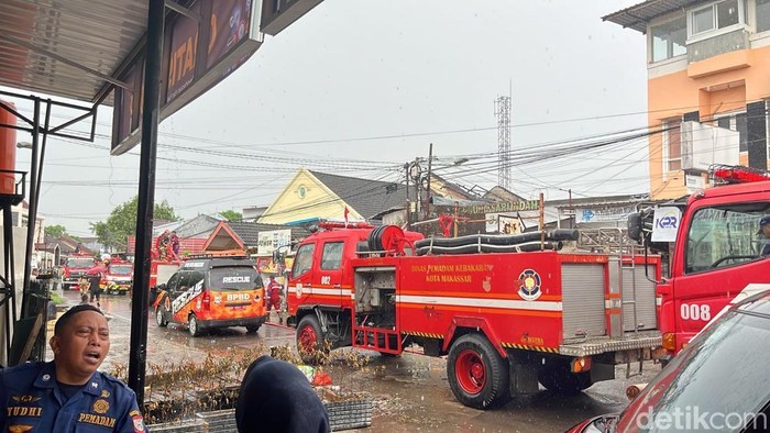 Petugas Damkar melakukan pemadaman kebakaran rumah dua lantai di Emmy Saelan, Makassar.