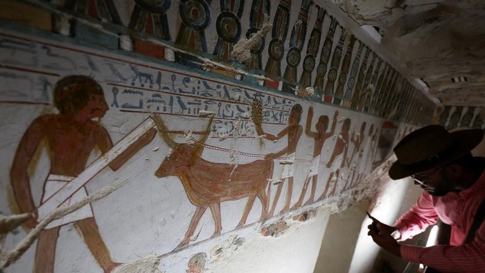 A visitor takes a photo inside the recently restored ancient 