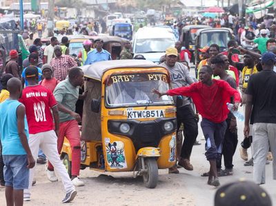 Protestors attempt to block a rickshaw taxi from carrying passengers during a strike by public transport operators driven by rising fuel costs linked to global supply pressures, in Mombasa, Kenya, May 18, 2026. REUTERS/Laban Walloga