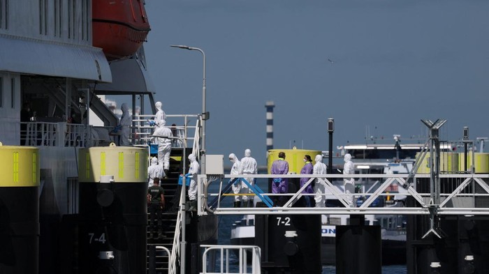 People in personal protective suits on board the cruise ship MV Hondius, which was affected by a hantavirus outbreak, after it arrived at the Port of Rotterdam, where Dutch authorities are preparing quarantine arrangements, in Rotterdam, Netherlands, May 18, 2026. REUTERS/Yves Herman     TPX IMAGES OF THE DAY