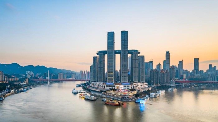 High rise buildings along the Chaotianmen River in Chongqing, China, and the sunset scenery of Chongqing Grand Theater