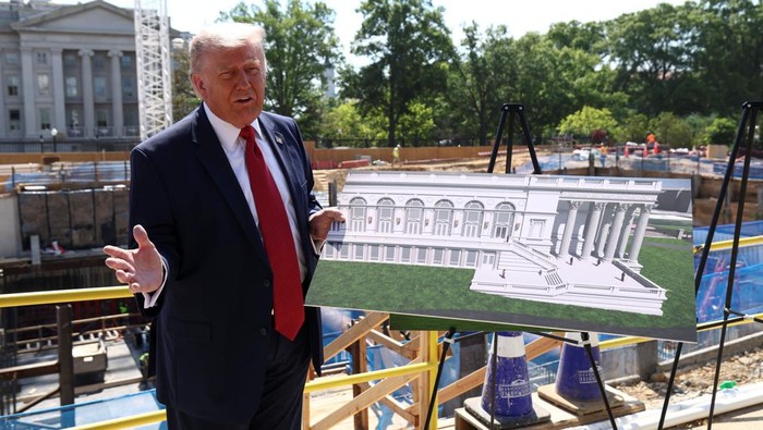 U..S. President Donald Trump shows images of the concept at the site of ongoing construction of the planned White House ballroom in Washington, D.C., U.S., May 19, 2026. REUTERS/Kevin Lamarque