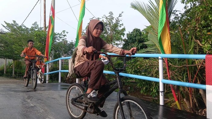 Senyum ceria anak-anak sekolah di Pelalawan kini punya jembatan yang aman.