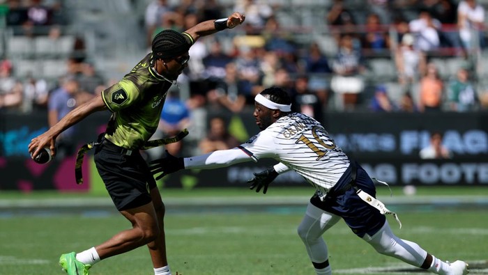 LOS ANGELES, CALIFORNIA - MARCH 21: Jayden Daniels #5 of Wildcats FFC avoids the hands of Terence Crawford #10 of Founder FFC during the Fanatics Flag Football Classic 2026 at BMO Stadium on March 21, 2026 in Los Angeles, California. (Photo by Harry 