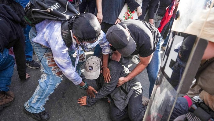 A protester lies on the ground during clashes with U.S. Immigration and Customs Enforcement (ICE) agents outside Delaney Hall in Newark, New Jersey, U.S., May 28, 2026. REUTERS/Ryan Murphy