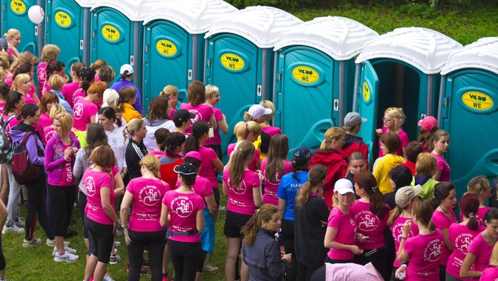 Ljubljana, Slovenia - June 2, 2012: Assembly of woman in lines waiting for toilet in Tivoli Park, Ljubljana. One is getting into it. This is before the start of traditional DM run.