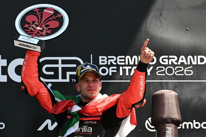 Winner Team Aprilia Racings Marco Bezzecchi celebrates on the podium with the trophy after the Italian Moto GP Grand Prix at Mugello circuit, in Mugello, near Florence, on May 31, 2026. (Photo by Andreas SOLARO / AFP)