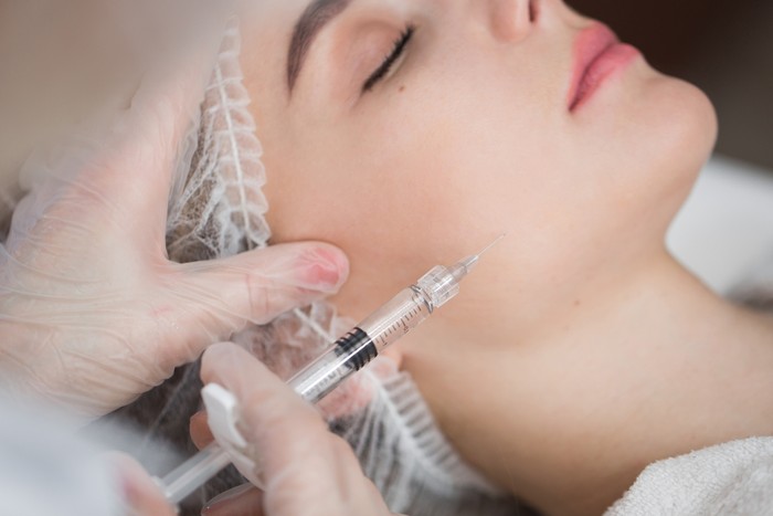 Woman having dark undereye circles and undergoing hylauronan acid treatment done to prevent it