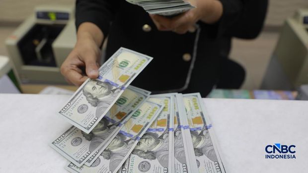 Pengunjung menukar uang di tempat penukaran uang di Money Changer Ayu Masagung kawasan Kwitang, Jakarta, Rabu, (3/6/2026). Nilai tukar rupiah kembali tertekan hingga menembus level Rp17.926 per dolar Amerika Serikat (AS) hari ini. (CNBC Indonesia/Muhammad Sabki)