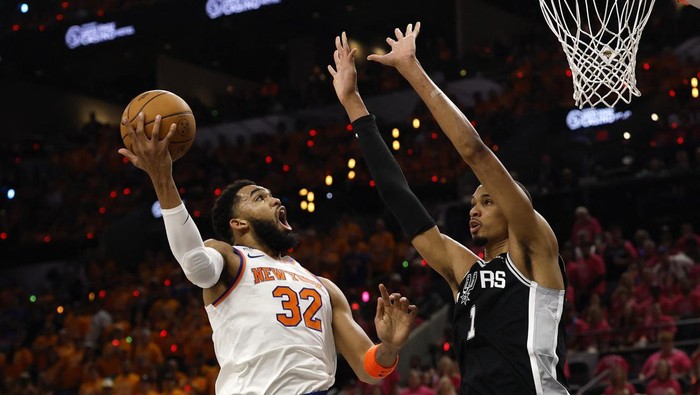 Jun 3, 2026; San Antonio, Texas, USA; New York Knicks center Karl-Anthony Towns (32) shoots the ball past San Antonio Spurs forward Victor Wembanyama (1) in the first half during game one of the 2026 NBA Finals at Frost Bank Center. Mandatory Credit: Geoff Burke-Imagn Images