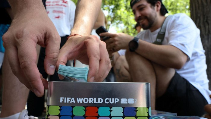 People gather to exchange stickers from a 2026 FIFA World Cup stickers album at El Rastro market, where several people gather every Sunday to swap duplicates, in Madrid, Spain, May 31, 2026. REUTERS/Kacper Pempel