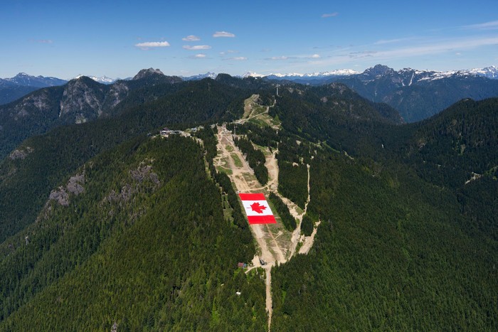 A giant Canadian flag, which Grouse Mountain officials say is approximately the size of two football fields, lies on a ski run at Grouse Mountain, ahead of the 2026 FIFA World Cup soccer tournament, in Vancouver, British Columbia, Canada, June 2, 202