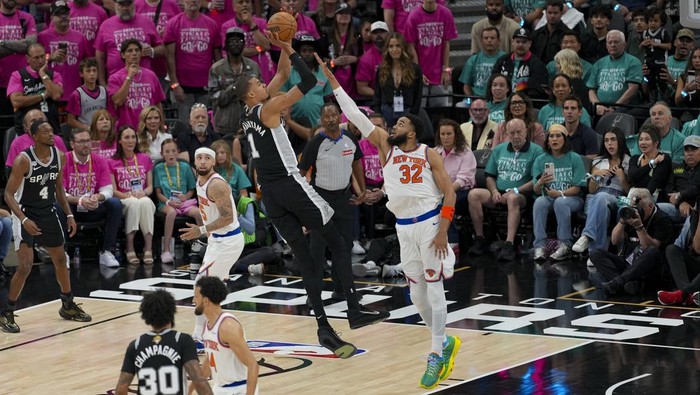 Jun 3, 2026; San Antonio, Texas, USA; San Antonio Spurs forward Victor Wembanyama (1) shoots the ball over New York Knicks center Karl-Anthony Towns (32) during the first half during game one of the 2026 NBA Finals at Frost Bank Center. Mandatory Credit: Daniel Dunn-Imagn Images