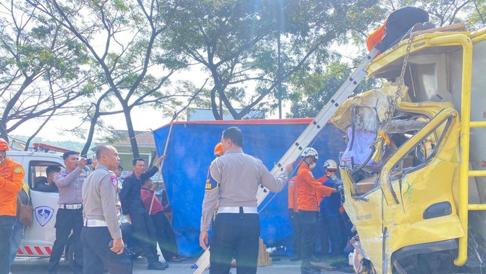 Petugas saat melakukan evakuasi kedua truk di Jalan Raya Bypass Cicalengka, Kampung Cipeutag, Desa Tenjolaya, Kecamatan Cicalengka, Kabupaten Bandung, Kamis (4/6/2026).