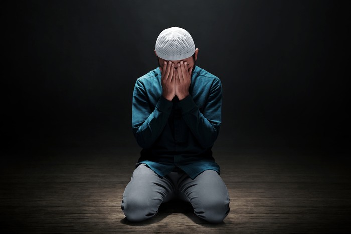 Muslim man praying in the mosque