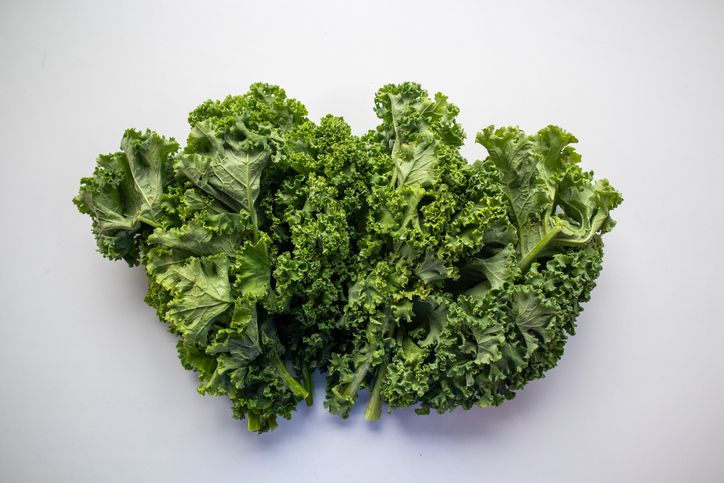 584879308 Fresh Kale Leaf isolated on white (excluding the shadow)