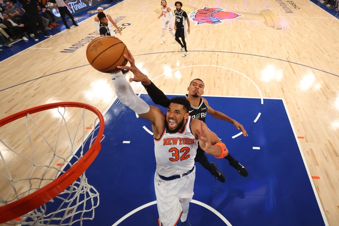 Jun 10, 2026; New York, New York, USA; New York Knicks center Karl-Anthony Towns (32) attempts a shot while being fouled by San Antonio Spurs forward Victor Wembanyama (1) during the first quarter in Game Four of the 2026 NBA Finals at Madison Square