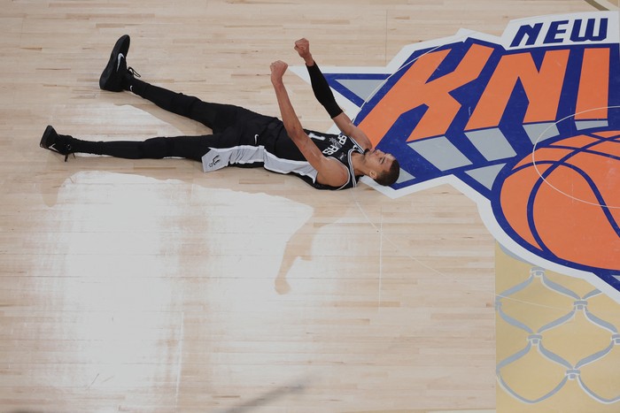 Jun 8, 2026; New York, New York, USA; San Antonio Spurs forward Victor Wembanyama (1) lies on the court and reacts against the New York Knicks during game three of the 2026 NBA Finals in the fourth quarter at Madison Square Garden. Mandatory Credit: 