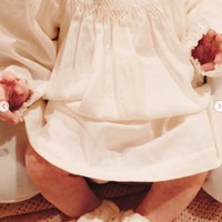 Baby Soleil tampil dengan dress putih. Dress tersebut dihiasi bentuk seperti bunga-bunga kecil 3D warna emas. Foto: Instagram/@alyssadaguise