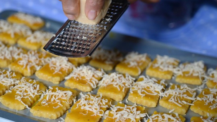Grated cheese in the process of making Oregano Kastangels cookies
