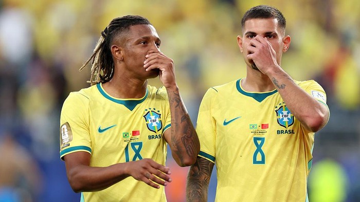 EAST RUTHERFORD, NEW JERSEY - JUNE 13: Danilo Santos #18 and Bruno Guimaraes #8 of Brazil cover their mouths to talk following the FIFA World Cup 2026 Group C match between Brazil and Morocco at New York New Jersey Stadium on June 13, 2026 in East Rutherford, New Jersey. (Photo by Dan Mullan/Getty Images)