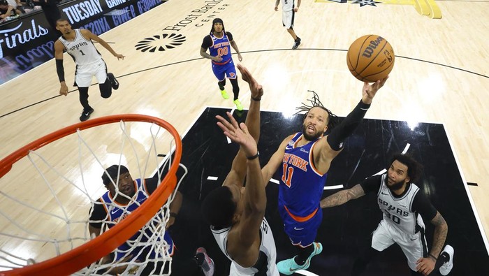 Jun 13, 2026; San Antonio, Texas, USA; New York Knicks guard Jalen Brunson (11) drives to the basket past San Antonio Spurs forward Julian Champagnie (30) during game five of the 2026 NBA Finals at Frost Bank Center. Mandatory Credit: Geoff Burke-Poo