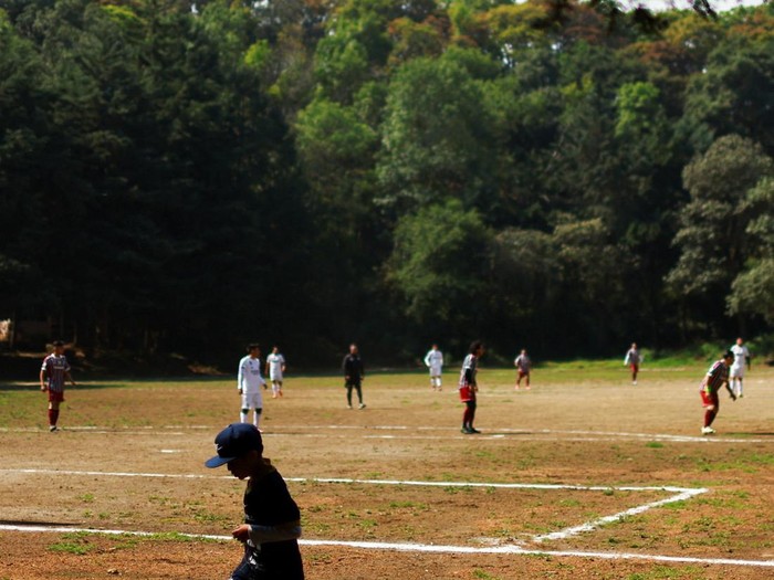 Locals play at the match San Isidro vs Real Bombay for the amateur soccer league games, at the 