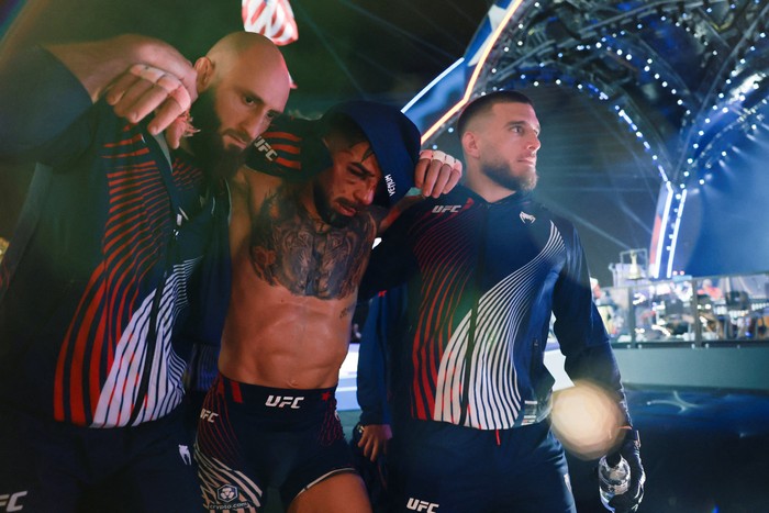 Ilia Topuria is assisted as he leaves after his loss to Justin Gaethje in their lightweight championship bout at UFC Freedom 250 at the White House in Washington, D.C., U.S., June 15, 2026. REUTERS/Jonathan Ernst