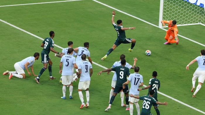 MIAMI, FLORIDA - JUNE 15: Abdulelah Al-Amri #4 of Saudi Arabia scores his teams first goal past Fernando Muslera #23 of Uruguay  during the FIFA World Cup 2026 Group H match between Saudi Arabia and Uruguay at Miami Stadium on June 15, 2026 in Miami, Florida. (Photo by Molly Darlington/Getty Images)