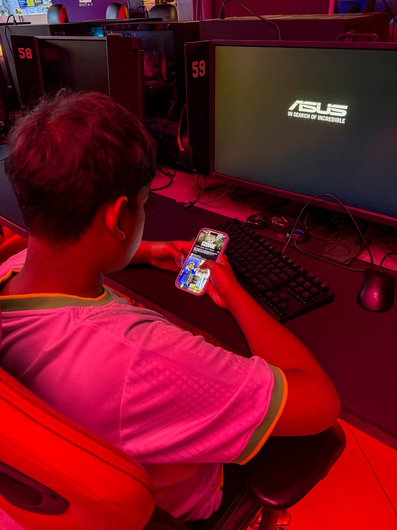 A boy looks at his mobile phone at a gaming centre, after the United Arab Emirates approved a resolution setting the minimum age for social media use at 15, in Dubai, United Arab Emirates, June 18, 2026. Picture taken with a mobile phone. REUTERS/Rula Rouhana