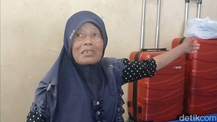 Kusriyati (65), jukir penyelamat uang Rp 3,6 miliar dari pencurian di Brebes menunjukan koper untuk umrah, Jumat (19/6/2026).