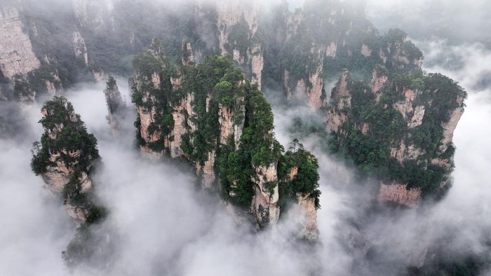 ZHANGJIAJIE, CHINA - JUNE 20: Aerial view of cloud-shrouded Zhangjiajie National Forest Park after rainfall on June 20, 2026 in Zhangjiajie, Hunan Province of China. (Photo by Deng Daoli/VCG via Getty Images)