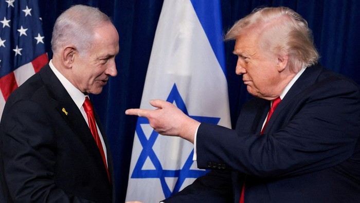 FILE PHOTO: U.S. President Donald Trump points his finger towards Israeli Prime Minister Benjamin Netanyahu as they shake hands during a press conference after meeting at Trump?s Mar-a-Lago club in Palm Beach, Florida, U.S., December 29, 2025. REUTER