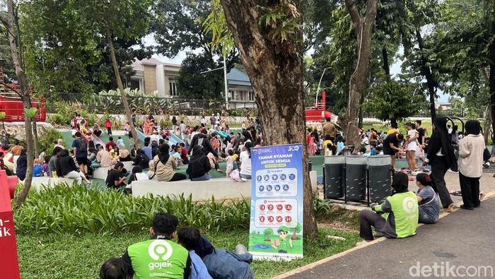 Terlihat driver ojol membawa anaknya berlibur ke Taman Bendera Pusaka di sela bekerja. (Adhfar/detikcom)