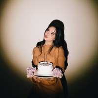 Lyodra tampil cantik kenakan dress simpel berwarna coklat. Rambut panjangnya tampak dibiarkan terurai. Sambil memegang kue ulang tahun, ia memamerkan pose duck face-nya. Foto: Instagram/@lyodraofficial