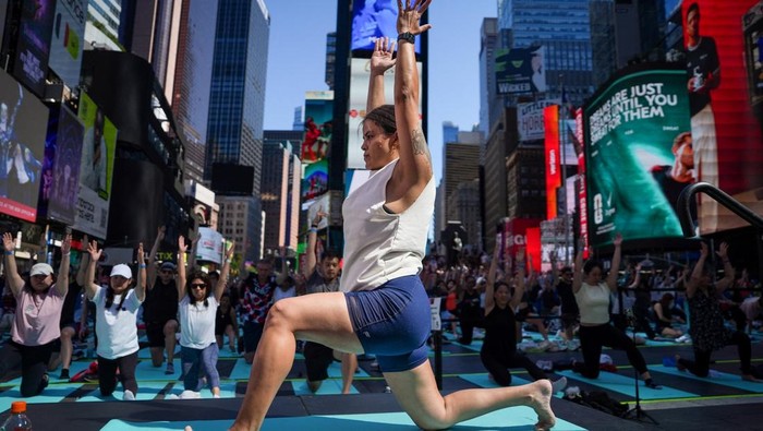 Yogis participate in a yoga class during the 24th annual 
