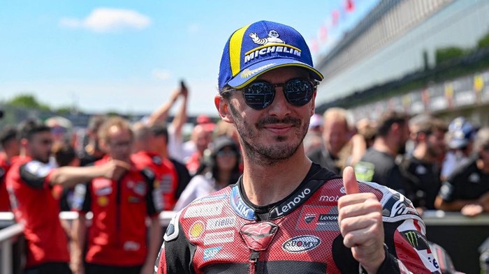 (FILES) Third placed Team Ducati Lenovo Teams Francesco Bagnaia shows the thumb up after the MotoGP Grand Prix of Czechia in Brno, Czech Republic, on June 21, 2026. Two-time former MotoGP champion Francesco Bagnaia will leave Ducatis factory team a