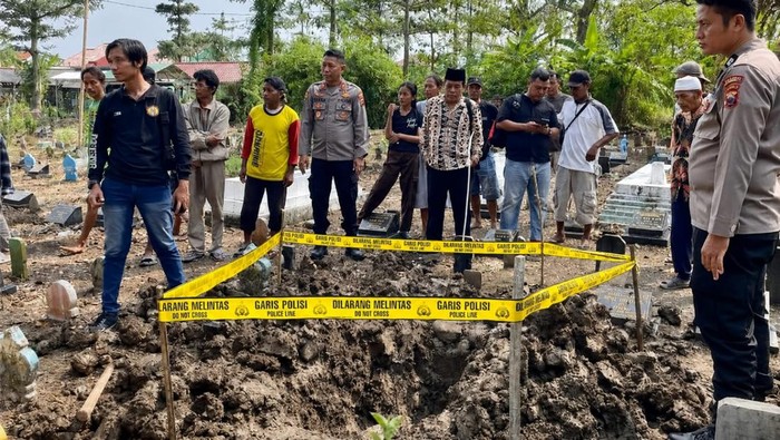 Makam warga diberi garis polisi.