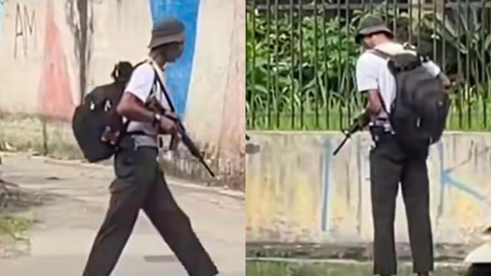 Pria yang viral menenteng senjata laras panjang.