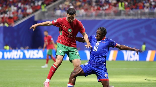 Wilson Isidor ATLANTA, GEORGIA - JUNE 24: (EDITOR'S NOTE: Image was captured using a remote camera from behind the goal.) Yassine Bounou #1 of Morocco dives in vain as Wilson Isidor #18 of Haiti scores his team's second goal during the FIFA World Cup 2026 Group C match between Morocco and Haiti at Atlanta Stadium on June 24, 2026 in Atlanta, Georgia. (Photo by Darrian Traynor/Getty Images)