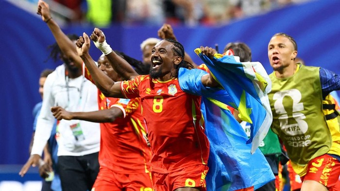 Soccer Football - FIFA World Cup 2026 - Group K - DR Congo v Uzbekistan - Atlanta Stadium, Atlanta, Georgia, U.S. - June 27, 2026 DR Congos Samuel Moutoussamy celebrates with their national flag after the match as they qualify for the knockout stages of the World Cup REUTERS/Bernadett Szabo     TPX IMAGES OF THE DAY