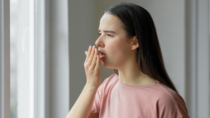 Woman sick and having cough