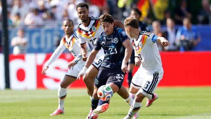 BOSTON, UNITED STATES - JUNE 29: (L-R) Matias Galarza of Paraguay, Felix Nmecha of Germany, Joshua Kimmich of Germany  during the  World Cup match between Germany  v Paraguay  at the Boston Stadium on June 29, 2026 in Boston United States (Photo by Marcel Bonte/Soccrates/Getty Images)