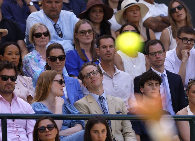 Tennis - Wimbledon - All England Lawn Tennis and Croquet Club, London, Britain - July 2, 2026 A tennis ball is seen as Britain's Catherine, Princess of Wales, former tennis player Andy Murray, and Anne Keothavong watch the second round match between Britain's Katie Swan and Madison Keys of the U.S. from the stands in Court 1 REUTERS/Andrew Couldridge