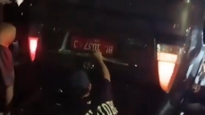 Mobil pelat merah yang terbalik usai kecelakaan.