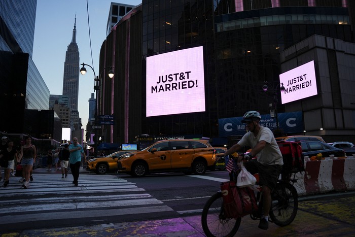 A screen displays a message referencing singer Taylor Swift and National Football League (NFL) player Travis Kelce outside Madison Square Garden, the venue for their reported wedding celebrations, in New York, U.S., July 3, 2026.  REUTERS/Angelina Katsanis